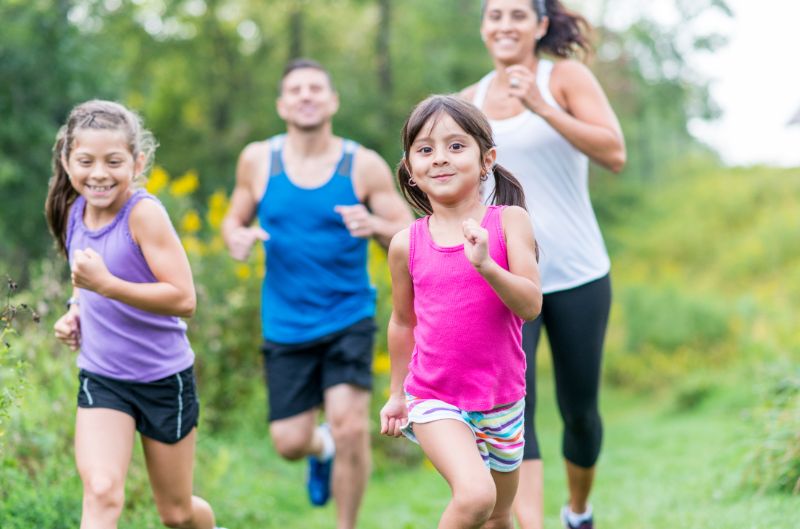 Father , Mother and two children's running in ground