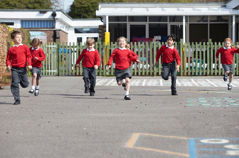 Kids playing at school playground with school uniform