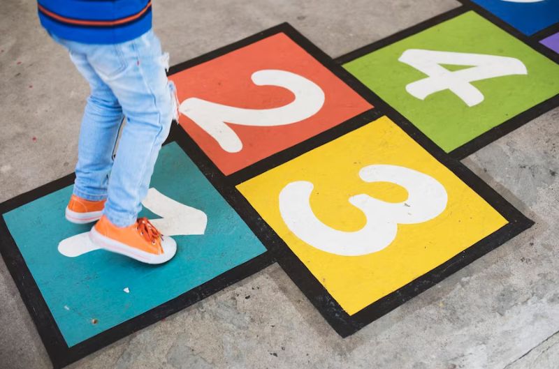 Kid playing hopscotch | Creative System